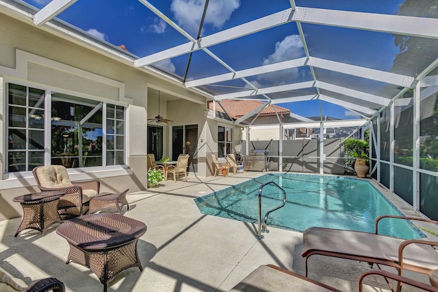 view of pool with a lanai, ceiling fan, and a patio area