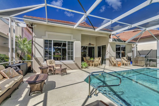 back of house with outdoor lounge area, a patio, ceiling fan, and glass enclosure