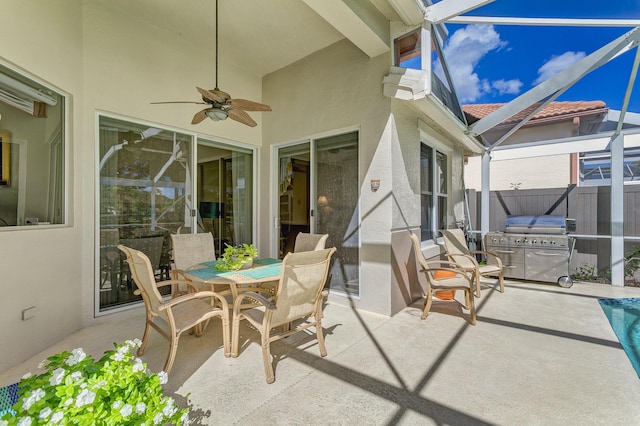 view of patio with a lanai, a grill, and ceiling fan