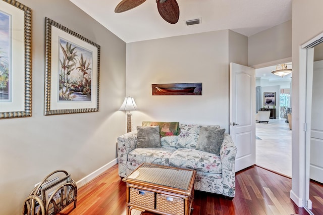 living area with hardwood / wood-style flooring and ceiling fan