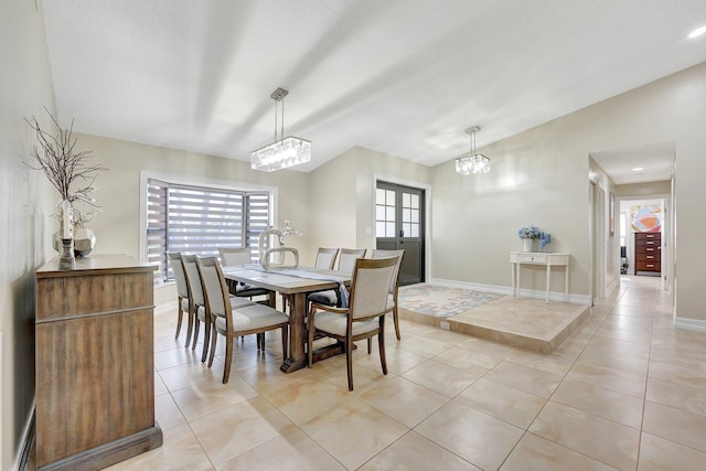 dining space featuring a textured ceiling, light tile patterned flooring, vaulted ceiling, french doors, and a chandelier