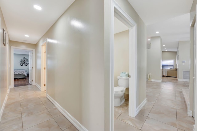 corridor featuring light tile patterned flooring