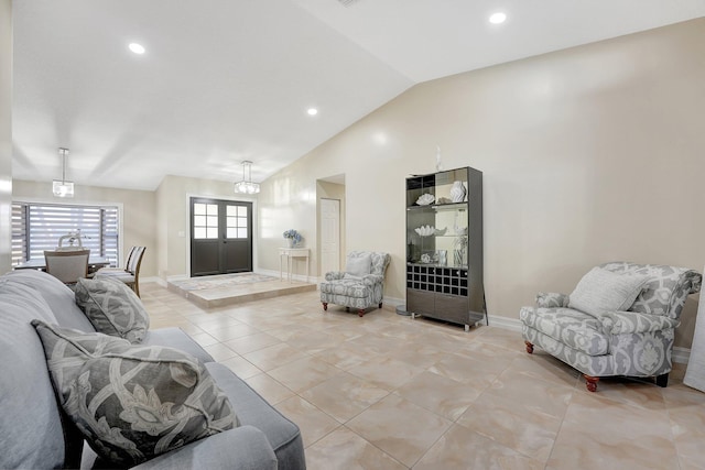 tiled living room with vaulted ceiling and a chandelier