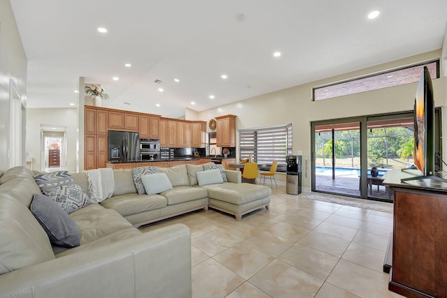 tiled living room featuring lofted ceiling and sink