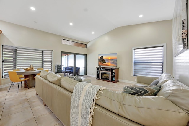 living room featuring vaulted ceiling and light tile patterned floors