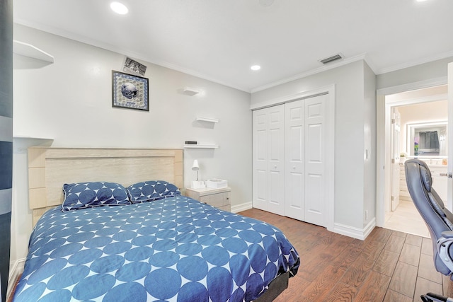 bedroom with crown molding, wood-type flooring, and a closet