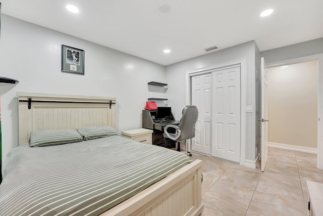 tiled bedroom with a closet