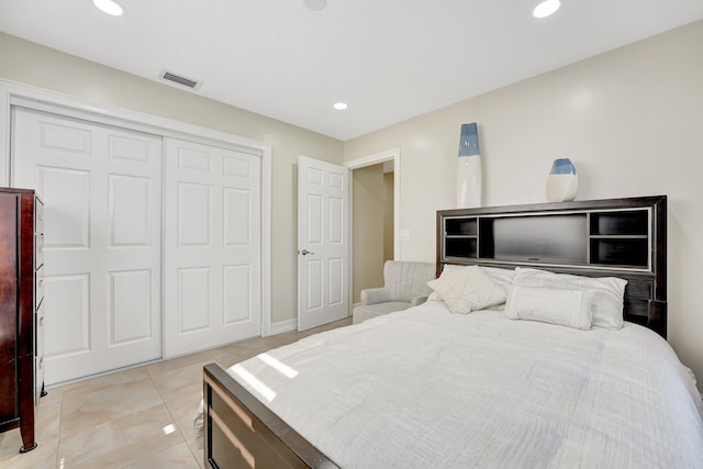 bedroom with light tile patterned floors and a closet