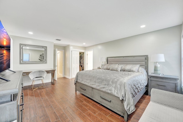 bedroom with hardwood / wood-style floors and a closet