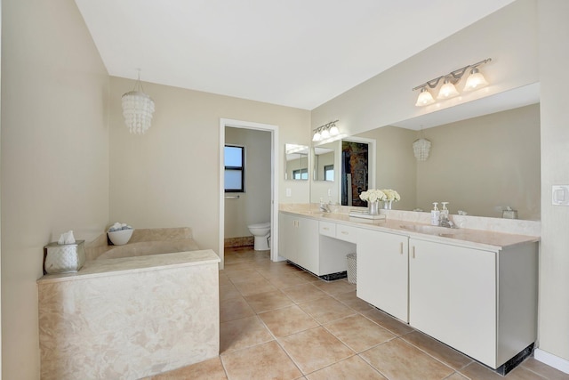 bathroom with vanity, tile patterned floors, and toilet