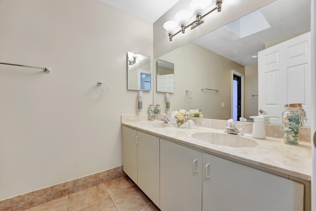 bathroom with vanity, tile patterned floors, and a skylight