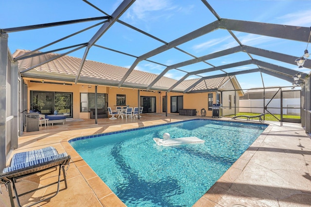 view of swimming pool featuring glass enclosure and a patio area