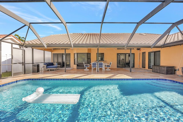 view of swimming pool with a patio and glass enclosure