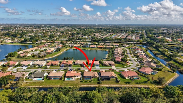 birds eye view of property with a water view