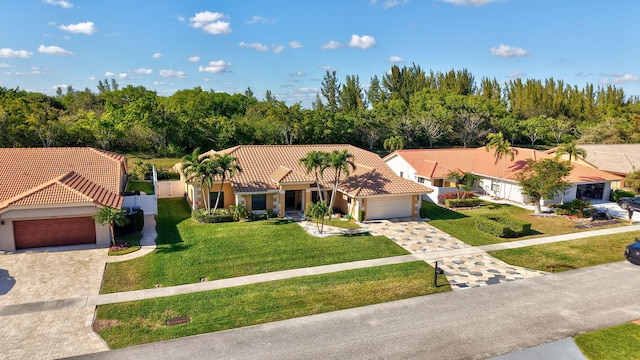 view of front of home with a garage and a front lawn