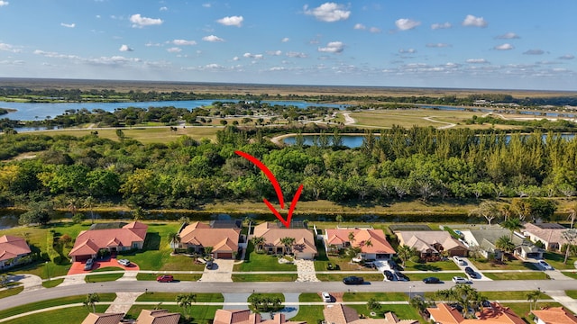 birds eye view of property with a water view