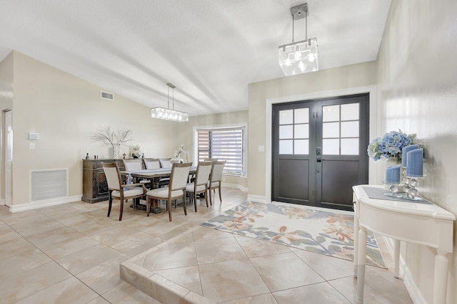 tiled foyer featuring vaulted ceiling and french doors