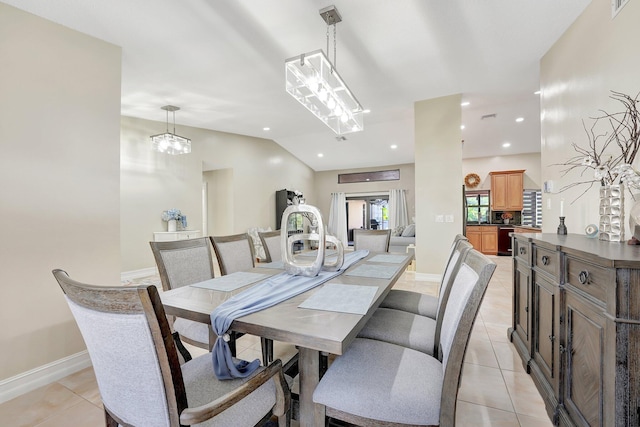 dining room featuring light tile patterned flooring and lofted ceiling