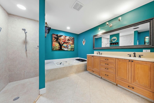 bathroom with tile patterned floors, shower with separate bathtub, and vanity