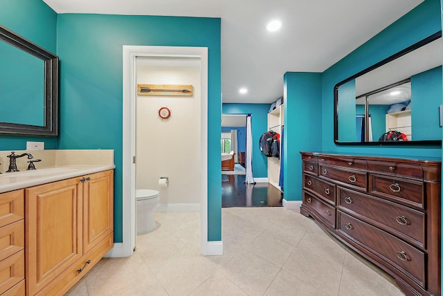 bathroom with tile patterned flooring, vanity, and toilet