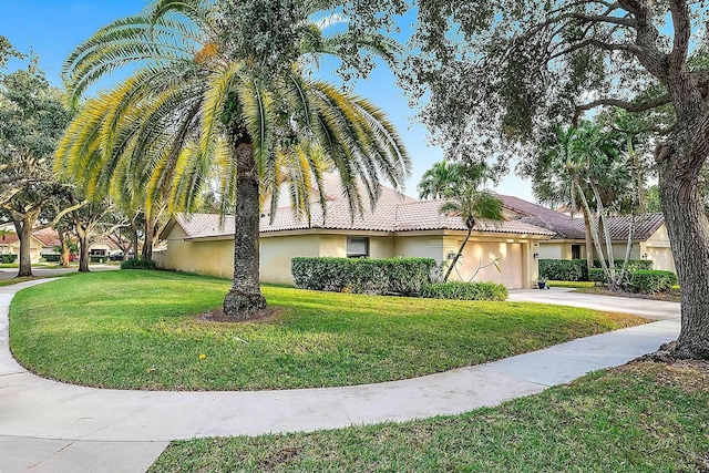 view of front of property featuring a garage and a front lawn