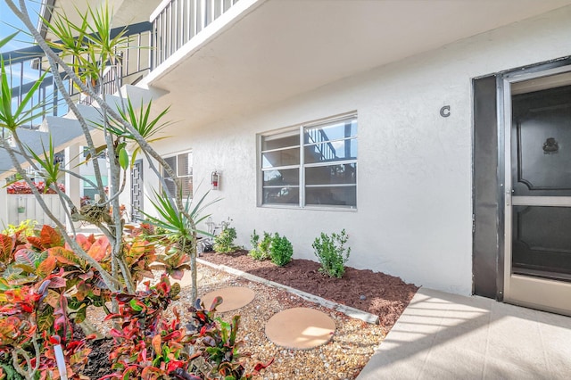 doorway to property with stucco siding