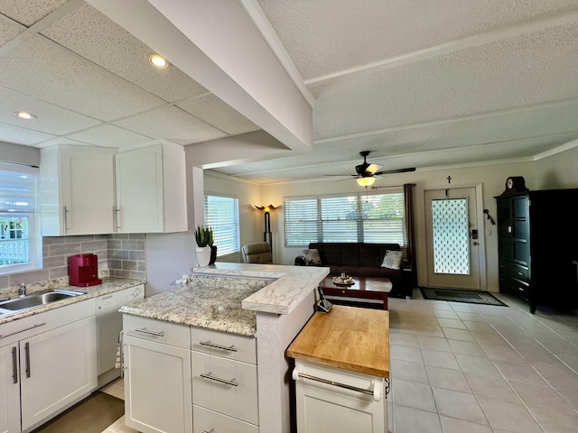 225 Westbury L 225, Deerfield Beach, FL 33442 - kitchen featuring open floor plan, white cabinetry, decorative backsplash, and white dishwasher