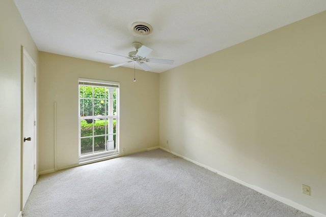 spare room featuring baseboards, visible vents, carpet floors, and ceiling fan