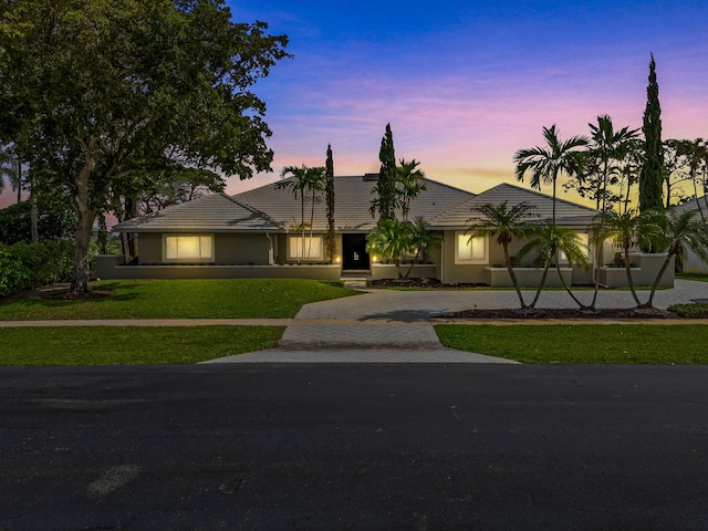 ranch-style house featuring a yard