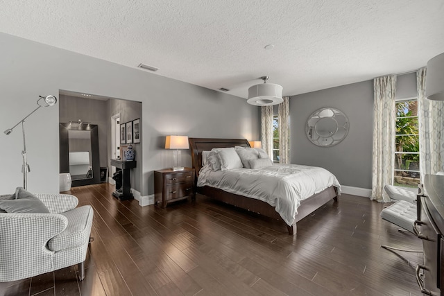 bedroom featuring dark wood-type flooring and a textured ceiling