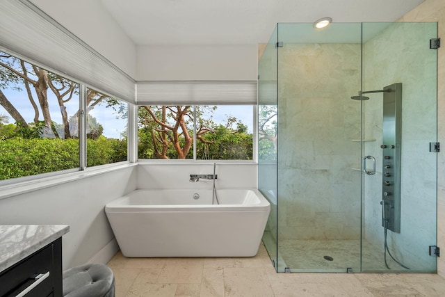 bathroom featuring vanity and separate shower and tub