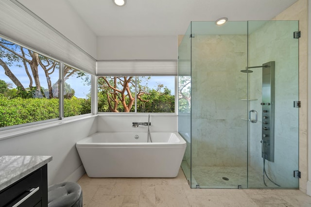 bathroom featuring vanity and separate shower and tub