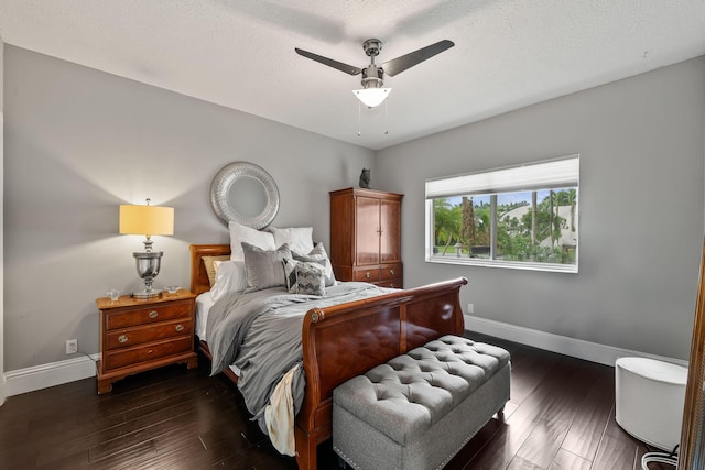 bedroom featuring ceiling fan, dark hardwood / wood-style floors, and a textured ceiling