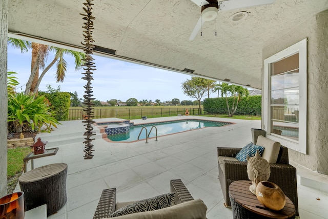 view of swimming pool with a patio, ceiling fan, and an in ground hot tub