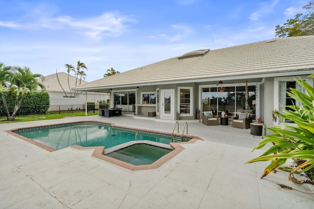 view of pool with an in ground hot tub, outdoor lounge area, ceiling fan, and a patio area