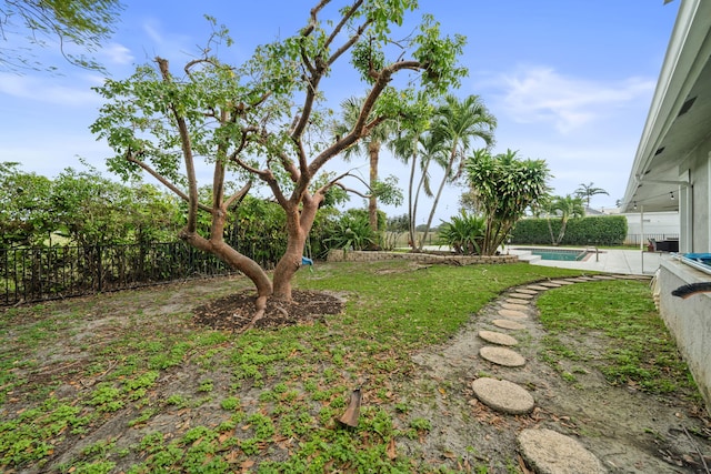 view of yard with a fenced in pool