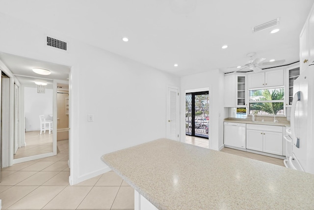 kitchen featuring white appliances, white cabinetry, visible vents, and glass insert cabinets