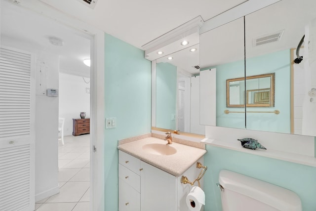 bathroom with tile patterned flooring, recessed lighting, vanity, visible vents, and a closet