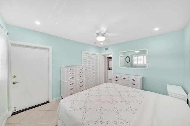 bedroom with light tile patterned floors, visible vents, baseboards, a ceiling fan, and a closet