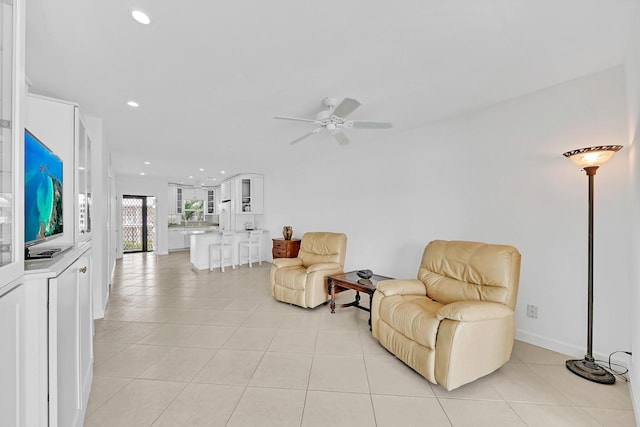 sitting room with recessed lighting, ceiling fan, and light tile patterned floors