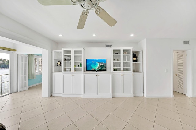 unfurnished living room featuring light tile patterned floors, visible vents, and a ceiling fan