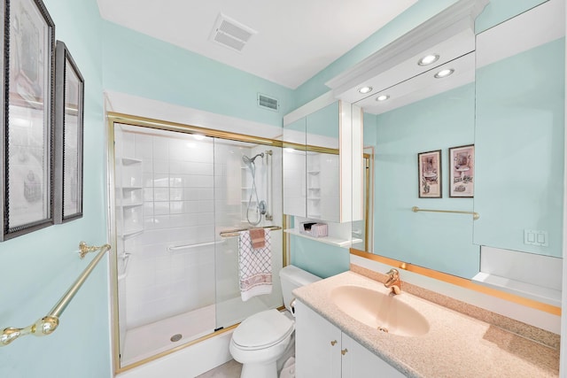 full bathroom featuring visible vents, toilet, vanity, and a shower stall