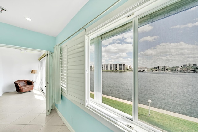 sunroom with a wealth of natural light and a water view