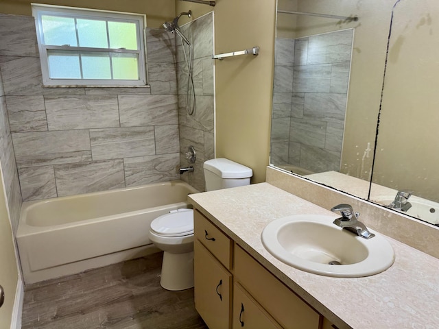 full bathroom with toilet, hardwood / wood-style flooring, tiled shower / bath combo, and vanity