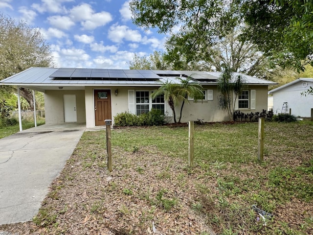 single story home featuring a carport and a front lawn