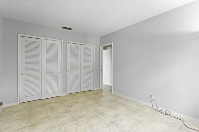 1821 N 50th Ave, Hollywood, FL 33021 - unfurnished bedroom with multiple closets and baseboards