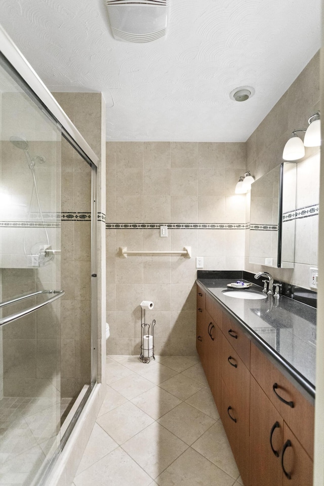1821 N 50th Ave, Hollywood, FL 33021 - bathroom featuring tile walls, vanity, a shower stall, tile patterned floors, and toilet