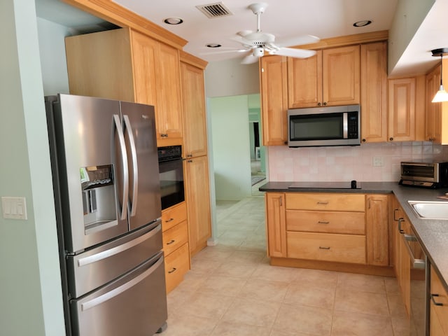 1821 N 50th Ave, Hollywood, FL 33021 - kitchen featuring black appliances, tasteful backsplash, a ceiling fan, dark countertops, and light brown cabinets