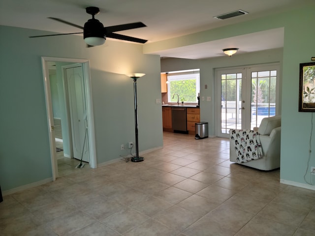 1821 N 50th Ave, Hollywood, FL 33021 - living room featuring french doors, a ceiling fan, light tile patterned floors, and baseboards