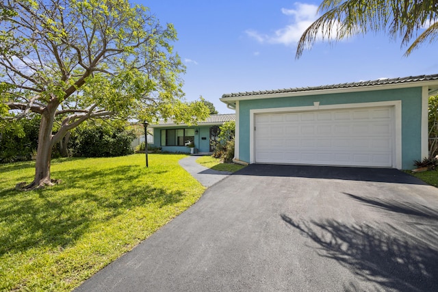 1821 N 50th Ave, Hollywood, FL 33021 - ranch-style house with stucco siding, asphalt driveway, a front yard, and a tile roof